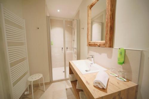 a bathroom with a sink and a mirror at Landidyll Hotel Klostermühle in Münchweiler an der Alsenz