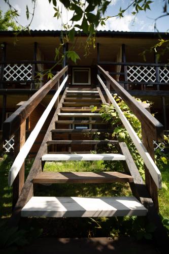a staircase leading up to a building with the sun shining on it at Sadyba u Gansa in Svityazʼ