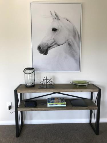a table with a picture of a horse on the wall at Maungatautari Outlook Cambridge in Cambridge