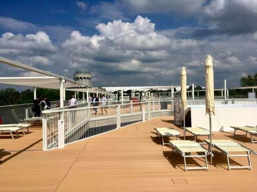 a deck of a cruise ship with tables and chairs at Ruben Apartman City Center in Debrecen