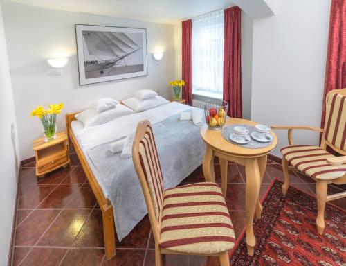 Ένα ή περισσότερα κρεβάτια σε δωμάτιο στο Murena Hotel i Restauracja
