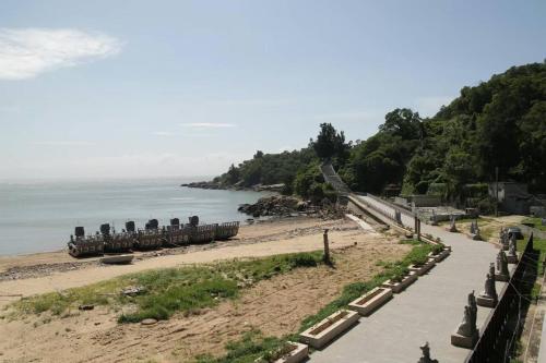 a beach with a train on it next to the water at 馬港驛站 Oldharbor Hostel in Nangan