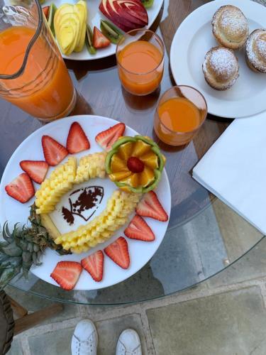 a plate of food with fruit on a table at Palazzo Castriota in Alezio