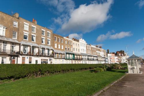 a row of buildings with grass in front of them at The Royal Harbour Hotel in Ramsgate
