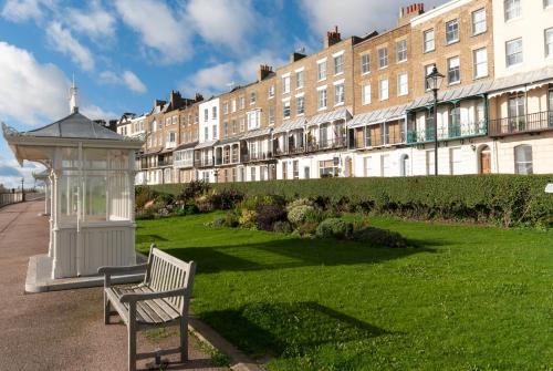 a bench in a park in front of a building at The Royal Harbour Hotel in Ramsgate