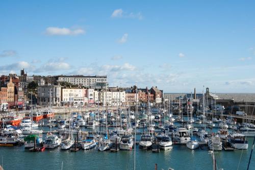 a bunch of boats are docked in a harbor at The Royal Harbour Hotel in Ramsgate