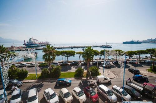 a parking lot with a bunch of cars parked near the water at STELLA MARIS GAETA in Gaeta