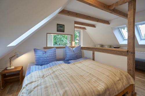 a bedroom with a large bed in a attic at Heuboden in Mellenthin
