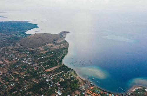 an aerial view of the ocean and a island at TEGAL SARI, Pemuteran- North Bali in Pemuteran
