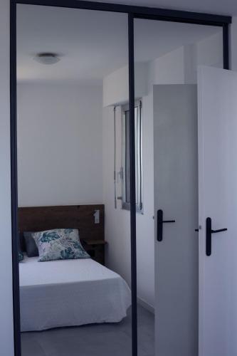 a bedroom with a bed and a glass door at Mare e Vista in Ajaccio