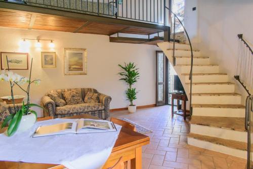a living room with a staircase and a couch at Borgo San Valentino in Arrone