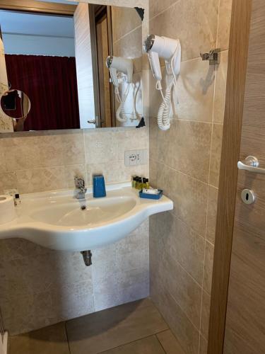 a bathroom with a sink and a mirror at Hotel Stradivari in Milan