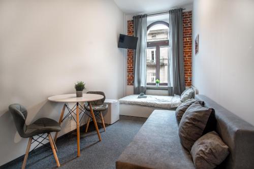 a living room with a couch and a table at Dream Aparts - Rewolucji 1905r in Łódź