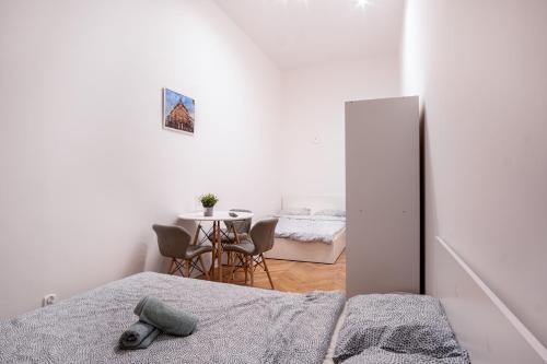 a room with a bed and a dining room with a table at Dream Aparts - Rewolucji 1905r in Łódź