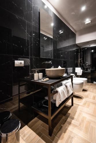 a black bathroom with a sink and a toilet at Corte Guelfa in Florence