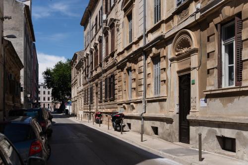 an old building with a motorcycle parked on the side of a street at Aurora Rooms B&B Pula in Pula