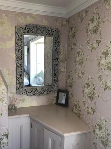 a mirror on the wall of a room at Parisien Parfumerie in Brighton & Hove