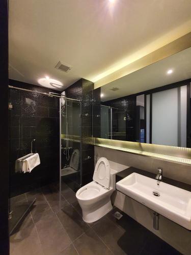 a bathroom with a toilet and a sink and a shower at GOOD DREAM PREMIER in Hat Yai