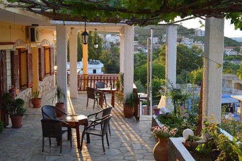 a patio with tables and chairs on a building at Sofia Kalyves in Kalyves