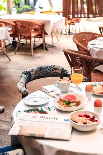 a table with plates of food and a glass of orange juice at Hotel & Restaurant Marina Palamós in Palamós