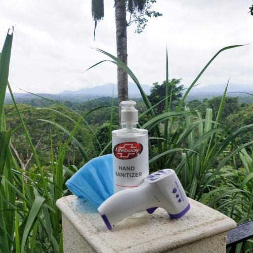 a bottle of hand sanitizer sitting on a sink at Forestdale Coorg in Virajpet