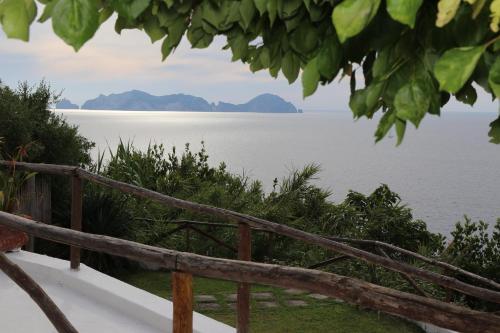 a view of the ocean from a wooden fence at casavictoria in Ponza