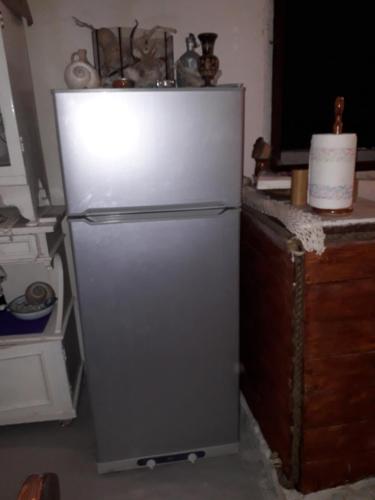 a white refrigerator in a kitchen next to a counter at Holiday home Stiniva in Vis