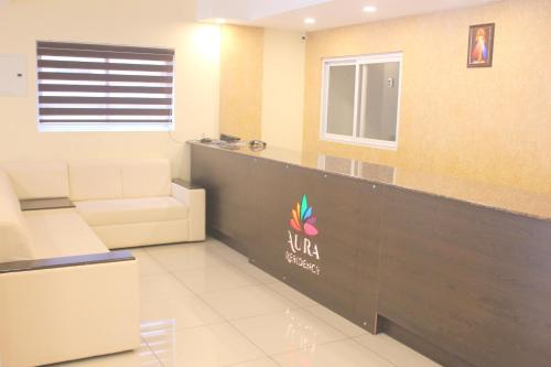 a waiting room at a salon with a counter at Aura Residency in Trichūr
