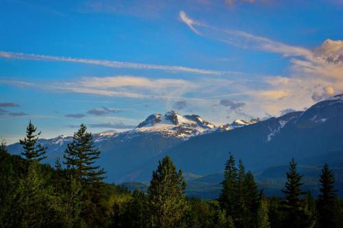 a view of a mountain range with trees in the foreground at Stoke Hotel SureStay Collection by Best Western in Revelstoke