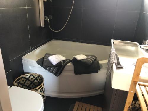 a bathroom with a bath tub and a sink at Mijn Kleinhof in Westouter