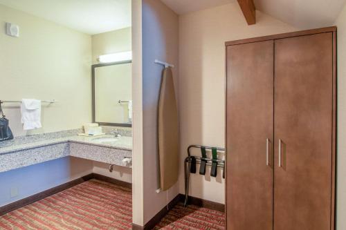 a bathroom with a sink and a large mirror at Quality Inn near Rocky Mountain National Park in Estes Park