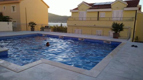 a person swimming in a swimming pool in a house at Villa Luna in Trogir