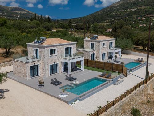 an aerial view of a villa with a swimming pool at Diosas Luxury Villas in Pilaroú