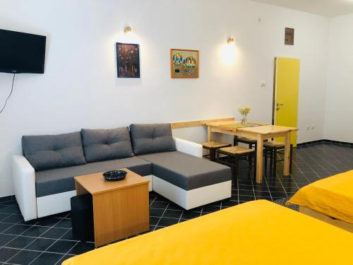 ein Wohnzimmer mit einem Sofa und einem Tisch in der Unterkunft Apartments Zlatiborski visovi in Zlatibor