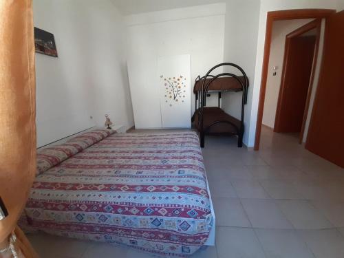a bedroom with a bed and a chair at IL TEMPO in Aielli
