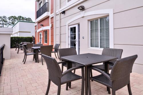 a row of tables and chairs on a patio at Holiday Inn Express Tampa North Telecom Park, an IHG Hotel in Tampa