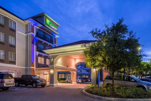a hotel with cars parked in a parking lot at Holiday Inn Express Tampa North Telecom Park by IHG in Tampa