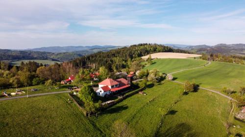 an aerial view of a house in a green field at Ubytování Na prženských pasekách in Mikulŭvka