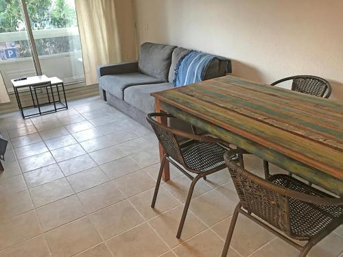 a living room with a couch and a table and chairs at Promenade résidence hoteliére in Nice