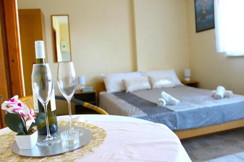 a bedroom with a bed and a table with wine glasses at Apartments Nature in Omiš