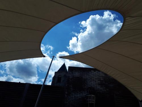 a view of a building through a window at Au Paradis Guesthouse in Waregem