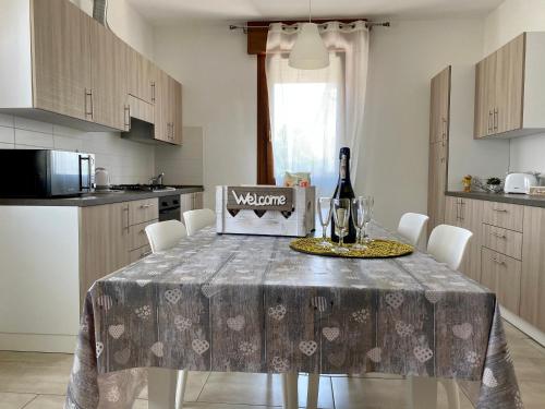 a kitchen with a table with a bottle of wine at Gondola House in Favaro Veneto