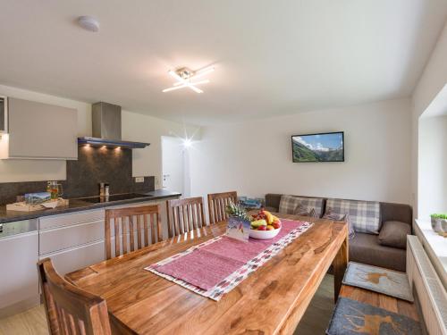 a kitchen and dining room with a wooden table at Berghäusl in Tux