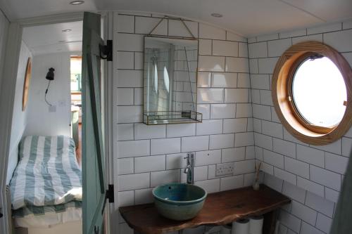 a bathroom with a sink and a mirror at Waterbeach Boatel in Cambridge