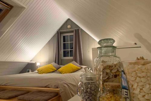 a bedroom with a bed with yellow pillows at Petit loft SAINT-MALO intra-muros in Saint Malo