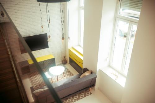 a living room with a couch in front of a fireplace at Zeus Design Loft Apartments in Vienna