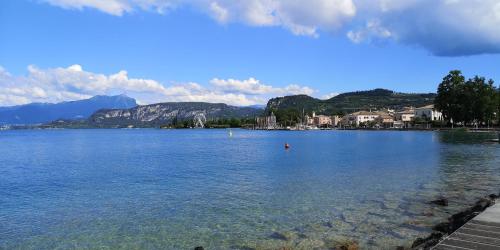 a large body of water with mountains in the background at Alessio Camere in Bardolino