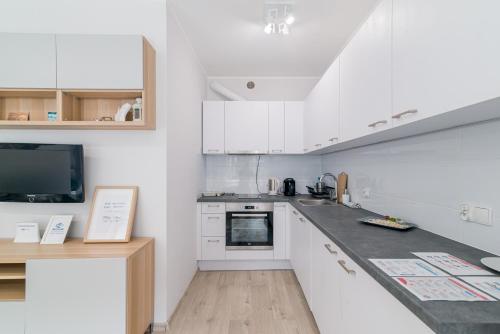 A cozinha ou cozinha compacta de Lux Apartment New&Nice Gdańsk