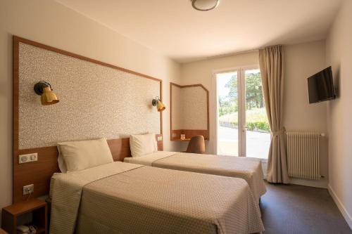 Ένα ή περισσότερα κρεβάτια σε δωμάτιο στο L'Ocean