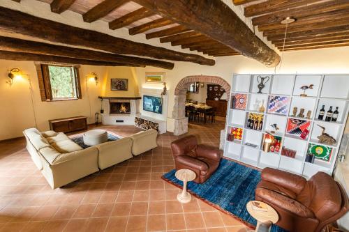 a living room with a couch and chairs and a fireplace at Casa al Gianni in Sovicille